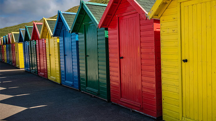 Brightly colored wooden beach changing booths.