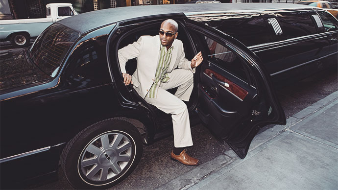 Young well dressed man getting out of limo.