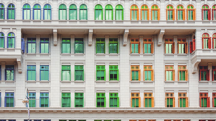 Multicolor window frames stone building.