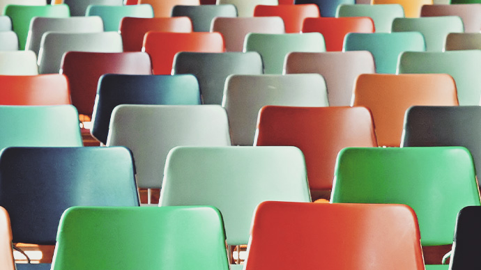 Rows of multi-colored plastic chairs.