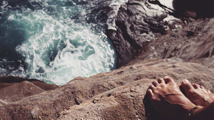 feet off cliff diver looking down