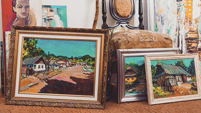 Collection of different types of handmade framed paintings in the workshop.