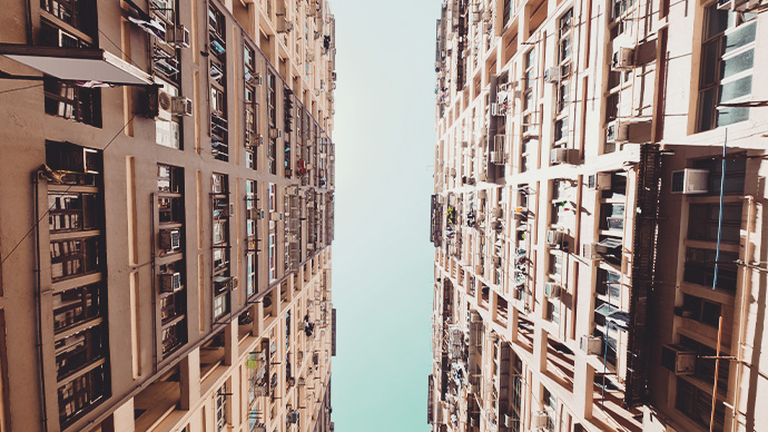 Looking up at large apartment blocks