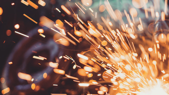 Close-up of welder working in workshop. Low depth of focus