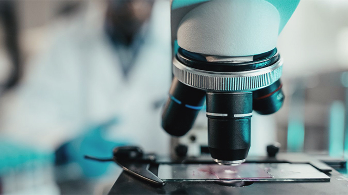 Side view of a microscope with glass slide underneath