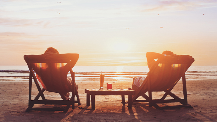 happy couple enjoy luxury sunset on the beach during summer vacations