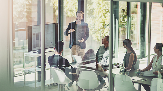 Business, people or tech in boardroom for conference, brand management or feedback chart. Man speaker, team or corporate presentation in office for company growth, explain or group performance review