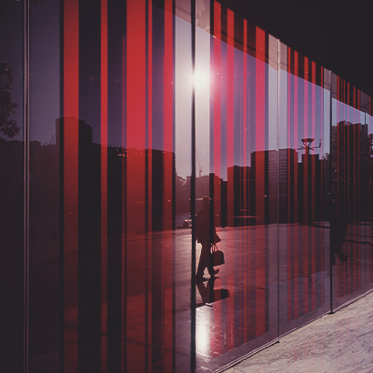 Businessperson Silhouette Abstract Glass Businessperson walking past abstract glass window