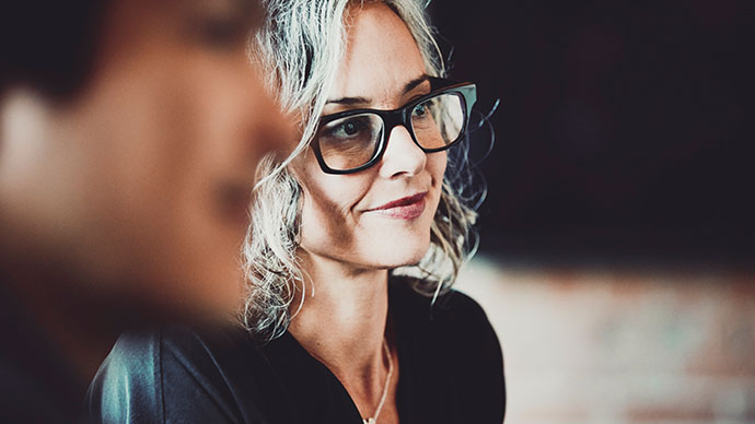 Woman with glasses in focus