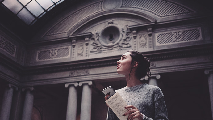 Portrait of a young attractive woman visiting museum or gallery