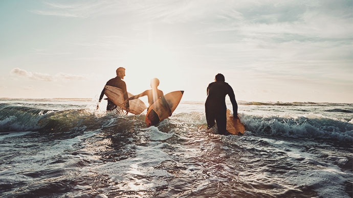 Multigeneration family men surfing