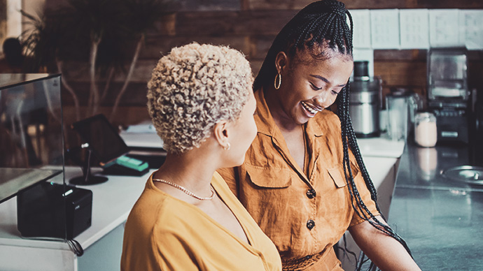 two women chatting at work