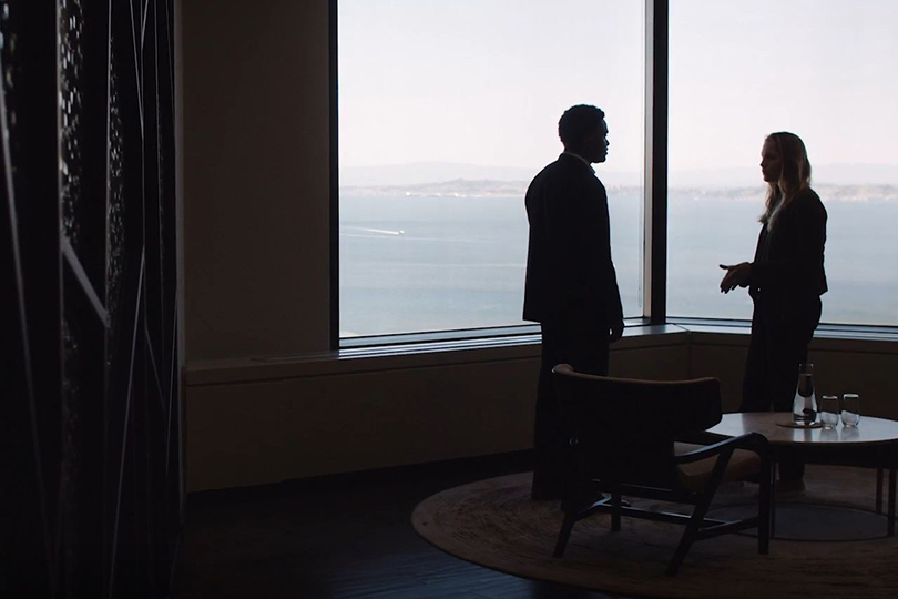 Professionals talking in an office with ocean views