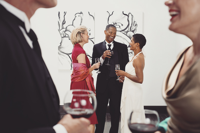 People socializing at a black-tie event