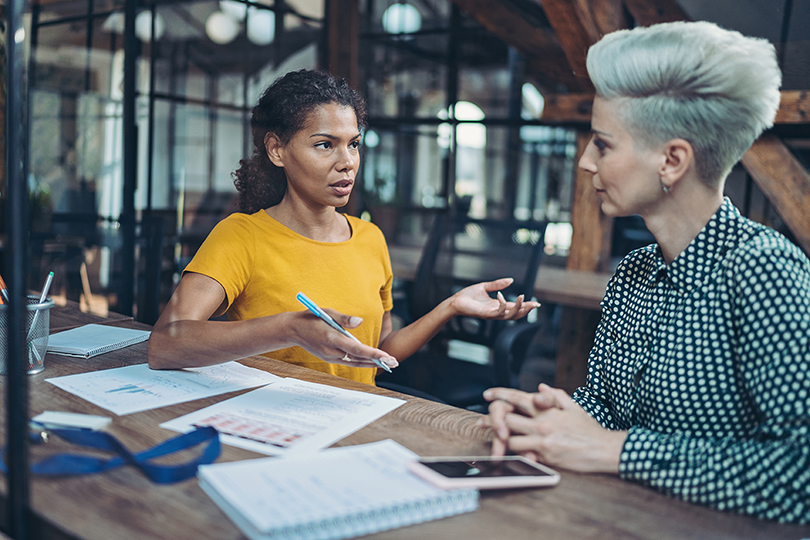 Two businesswomen talking in the office