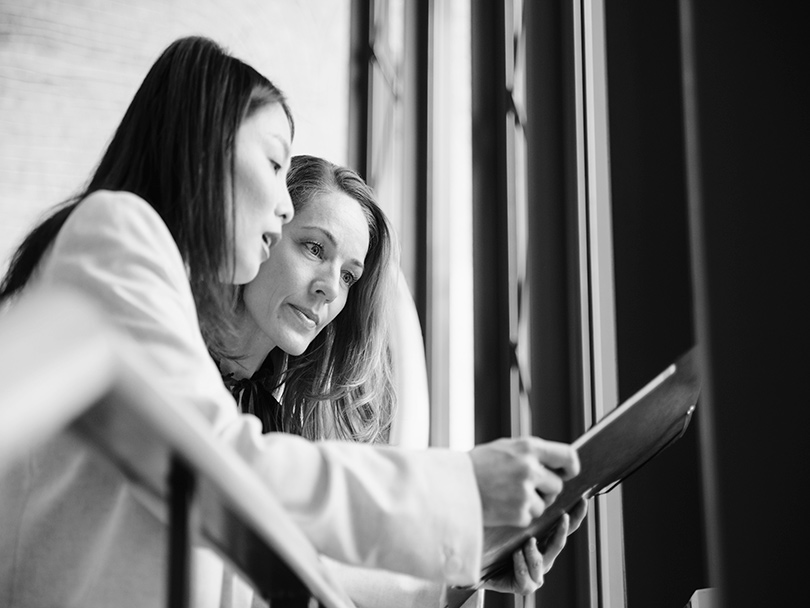 Two female Financial Advisors viewing tablet