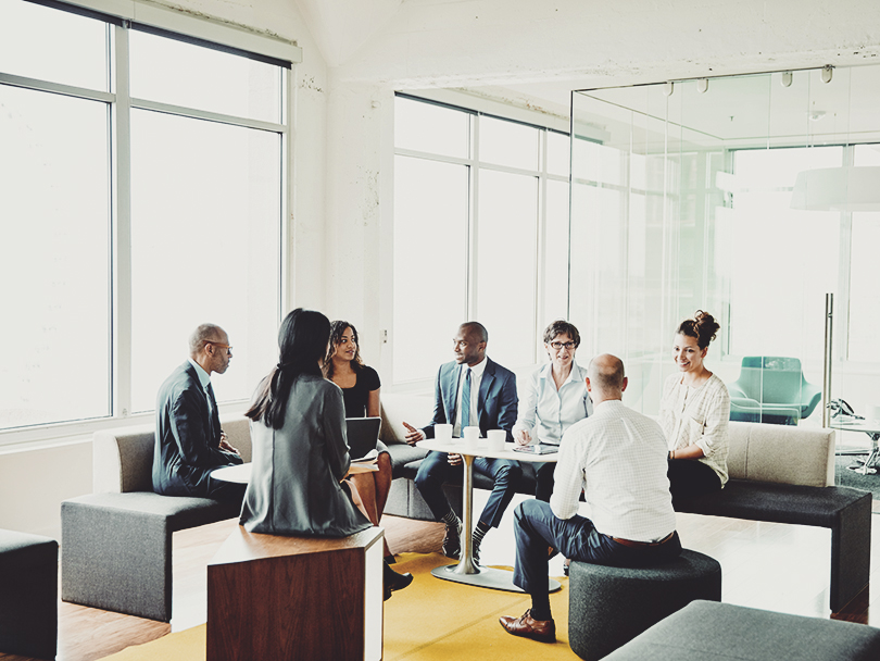 Group of businesspeople in discussion during project meeting in office