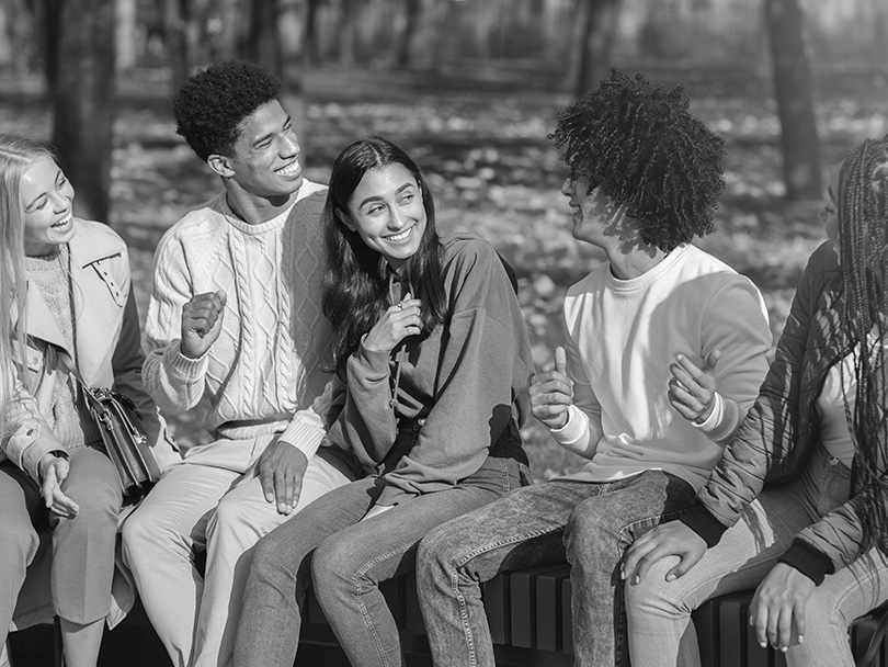 Carefree multiethnic teenagers having good time at public park