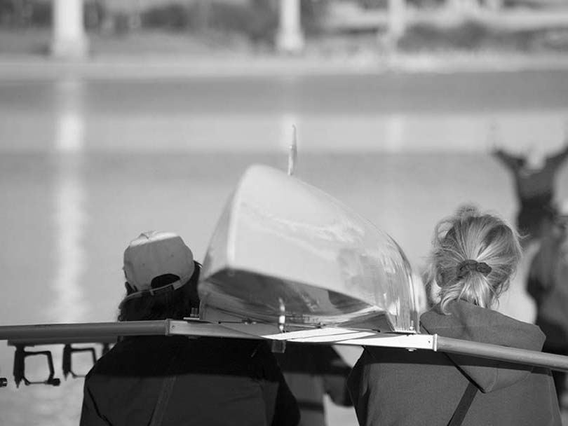 Couple carrying kayak to water