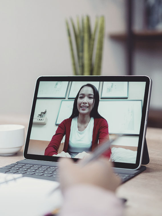 Young small business owner female working on video call by digital tablet at home.