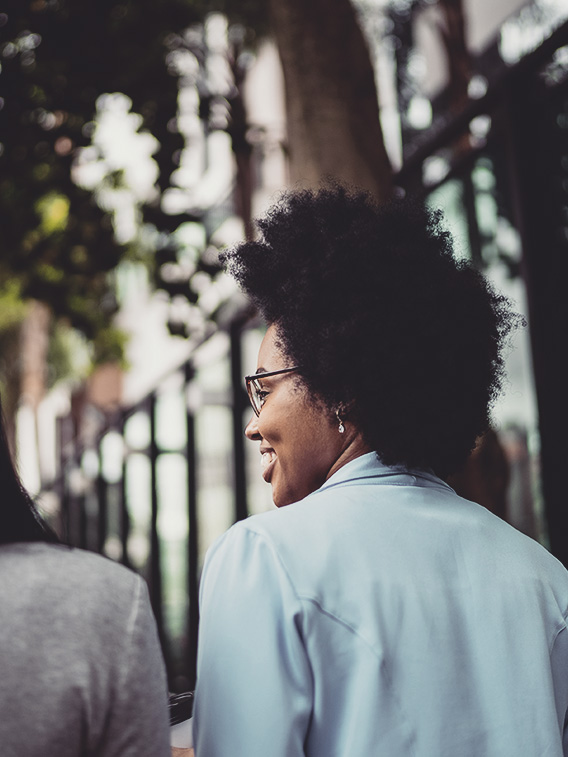 Woman smiling while walking with friend