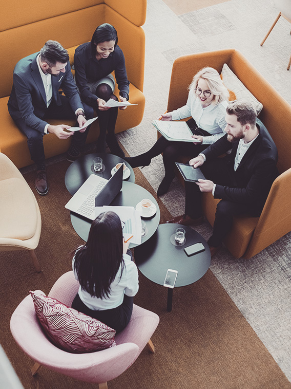 Group of business people in office cafeteria.