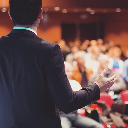 Presenter speaking at a forum Presenter speaking at a forum